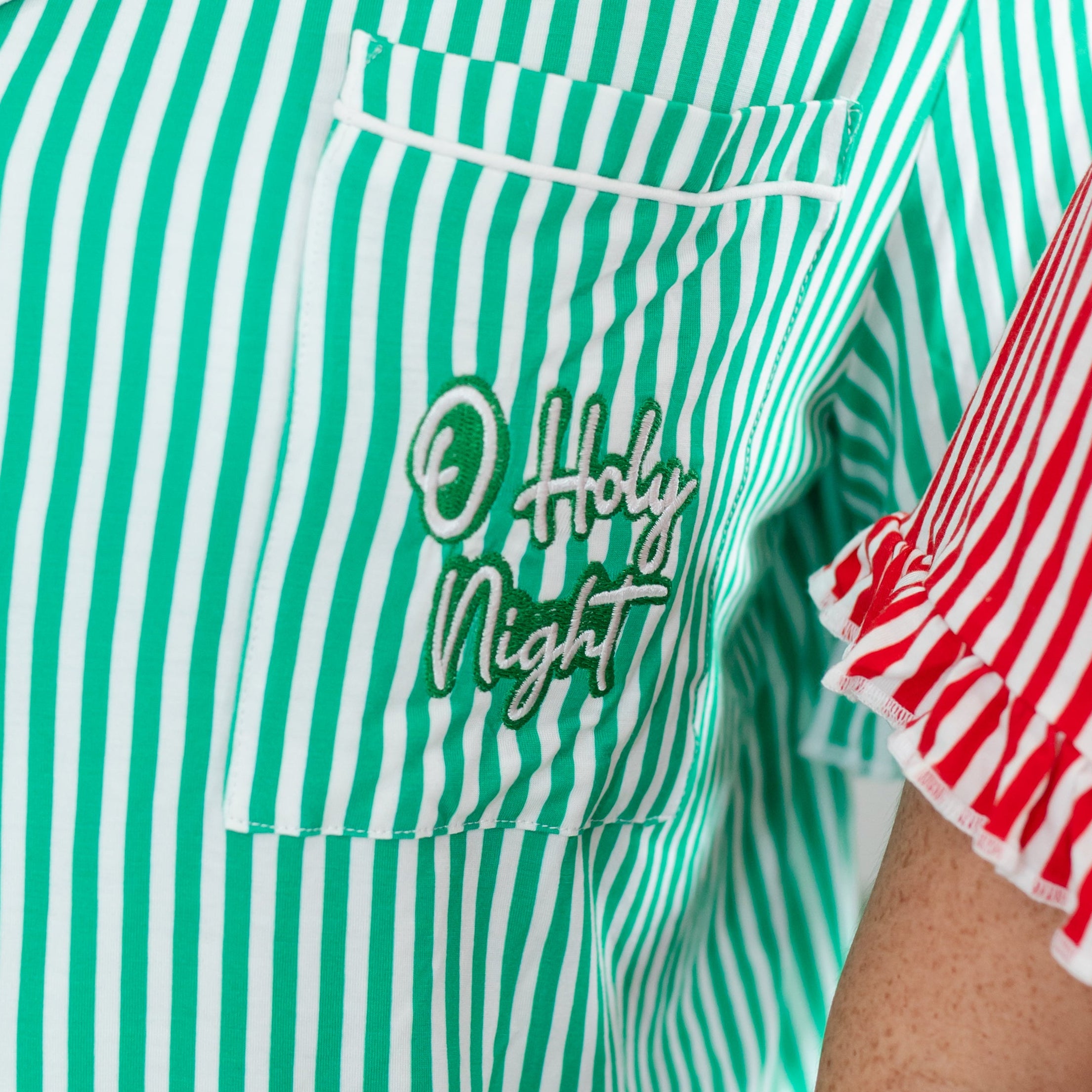 Green and white striped pajama top with 'O Holy Night' text on a person wearing it.