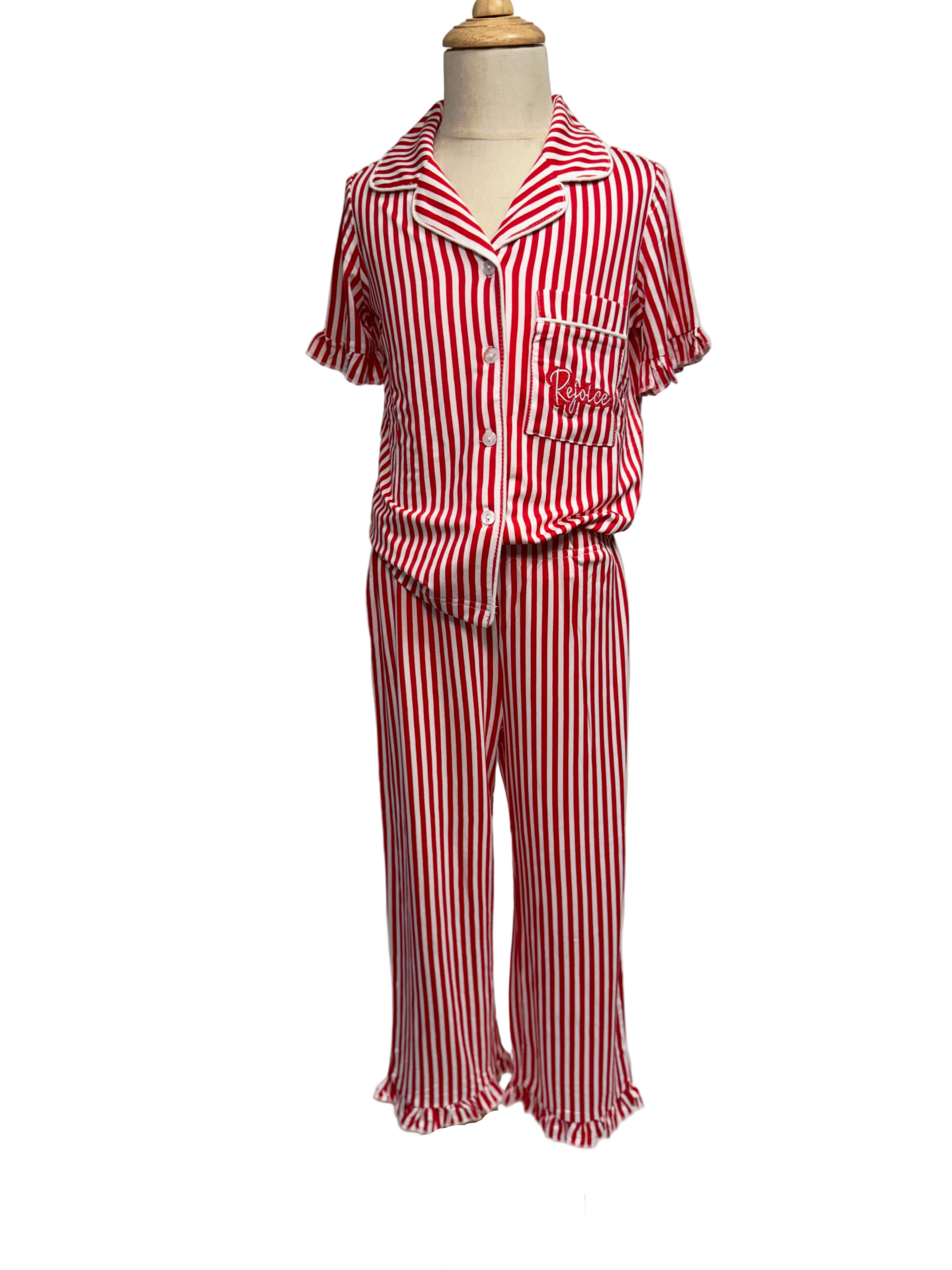 Red and white striped pajama set on a mannequin against a plain background