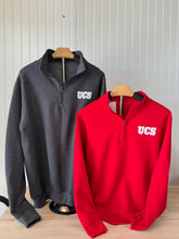 Load image into Gallery viewer, UCS Fleece 1/4-Zip Pullover Sweatshirts in Dark Heather Grey and Red, featuring the UCS logo on the chest, displayed on wooden hangers against a white paneled background
